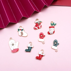 Macro view of Christmas enamel alloy pendants featuring holiday socks and gloves