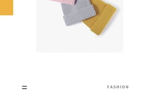 Close-up of thick knitted beanies in pink, grey and yellow with elastic rolled edges