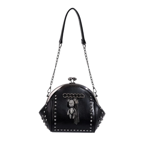 Black rivet shell shoulder bag with silver studs and crystal bear pendant on white background