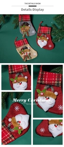 Detail of Christmas stockings with 3D Santa, reindeer, and snowman on pine branch background