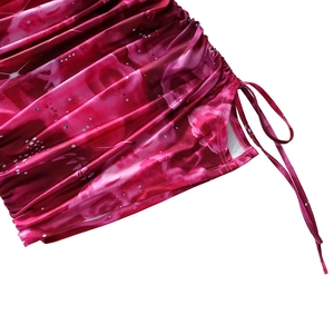 Close-up of pink floral pattern with side drawstring and ruched detail on the dress