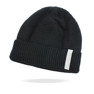 Close-up of the black ribbed knit beanie featuring a vertical weave and white patch detail