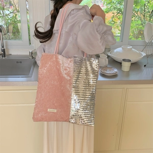 Detail of pink velvet and silver sequins on large tote bag shown on model