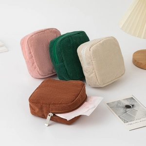 Detailed view of four colorful corduroy storage pouches for cosmetic and sanitary pads