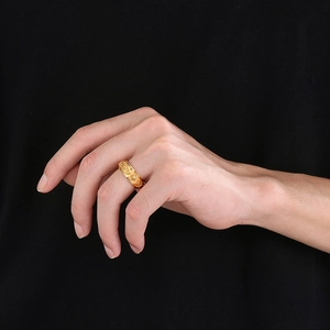 Detailed relief of sun and moon patterns on a spinning gold titanium ring for men