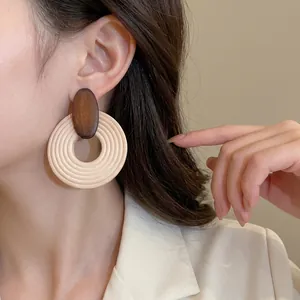 Minimalist wooden geometric circle hoop earrings with vintage brown drop on model