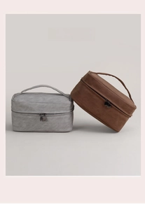 Luxe nubuck-textured cosmetic bags in light grey and dark brown with zip handles