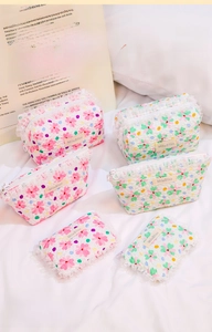 Three sizes of floral quilted pouches in pink and green with lace trim details