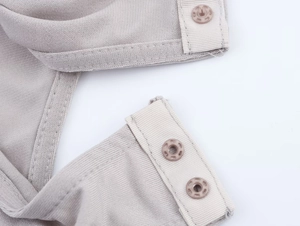 Close-up of grey tulle bodysuit featuring snap button closure and fine knit fabric detail