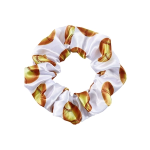 Detailed view of satin softball print scrunchie with smooth silk texture and pattern
