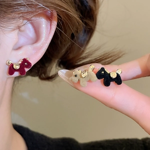 Macro detail of flocked Scottish Terrier puppy stud earrings with gold accents