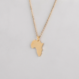 Macro shot of gold Africa map pendant with polished mirror finish on steel link chain