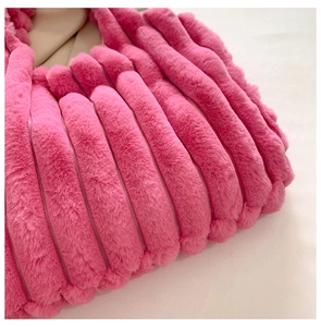 Detailed macro shot of the pink plush tote bag showing textured vertical stripe faux fur