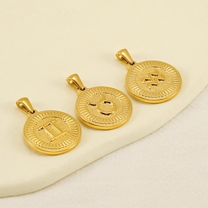 Three 18K gold circular zodiac pendants featuring Gemini, Taurus, and Aquarius symbols