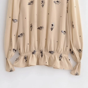 Blouse en mousseline pour femme avec paillettes noires et col montant à volants