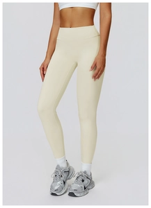 Detail shot of high-waisted cream yoga leggings with elastic tummy control fabric