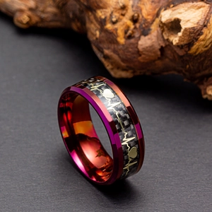 Detail of 8mm purple steel ring with black carbon fiber inlay and gold heartbeat pattern