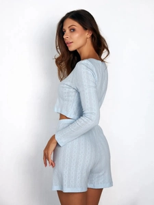 Detail of light blue hollow knit pajama set showing diamond texture and cropped fit