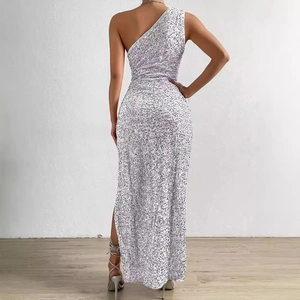 Rear view of elegant silver sequined one-shoulder maxi dress with high side slit detail