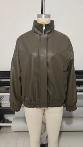 Detail view of olive green faux leather bomber jacket showing elastic cuffs and V-shaped seam