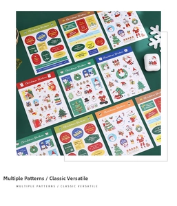 Detailed flat lay of colorful Christmas stickers featuring Santa, trees, and reindeer