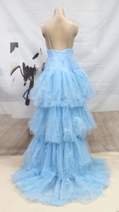 Detail of light blue tiered wedding dress with silver star sequins and open back