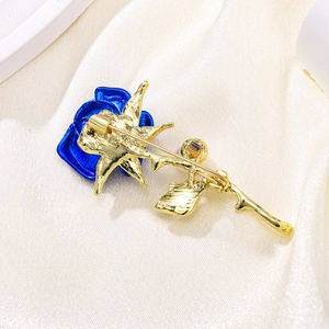 Elegant blue rose brooch with gold plating and pearl accents, back view showing pin