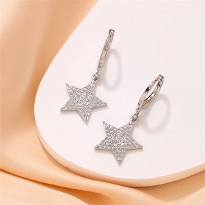 Elegant silver star earrings with pavé zircon stones on a white display stand