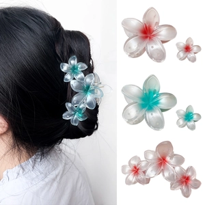 Gradient plumeria flower hair claw clips in pink and teal plastic for women's styling