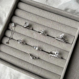Close-up of luxury S925 sterling silver rings with pear-cut zircon in velvet display box