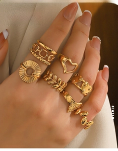 Detail shot of an 8-piece gold stainless steel ring set featuring diverse heart and leaf designs