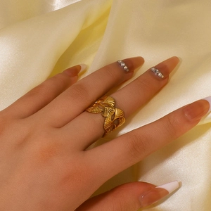 Minimalist 18K gold plated stainless steel ginkgo leaf ring on a silk background