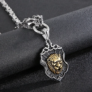 Macro shot of silver shield pendant with golden lion head on a Byzantine chain
