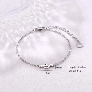 Macro detail of silver musical note bracelet showing dimensions and S925 hallmark