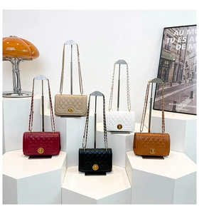 Detailed display of five colorful quilted flap bags with gold hardware and chain straps