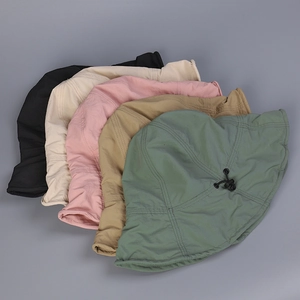 Detail showing multiple colors of foldable sun hats with adjustable drawstrings