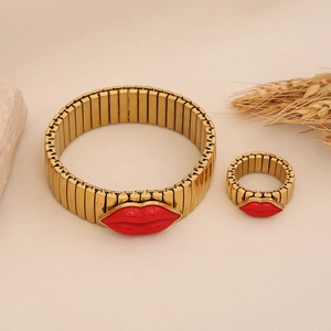 Gold adjustable bangle and ring set featuring vibrant red lip charms on minimalist stone base