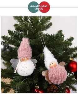 Close-up of plush Christmas angel ornaments with glitter wings on a festive Xmas tree