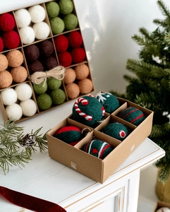 Close-up of handmade wool felt Christmas balls with festive patterns in a gift box