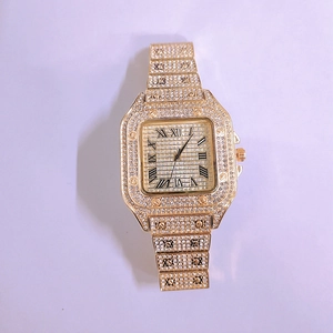 Detailed close-up of a gold square dial watch with Roman numerals and full crystal pave