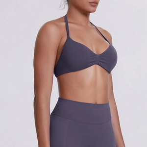 Detail view of seamless dark gray halter sports bra and high-waisted leggings set
