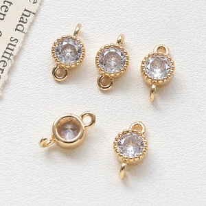 Macro shot of 5 gold-plated round heart connectors with clear zircon for DIY jewelry making
