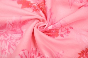 Detailed macro view of pink floral chiffon fabric with soft elegant pleated texture