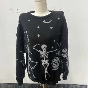 Detail of black Halloween knit sweater featuring white dancing skeletons and gravestones