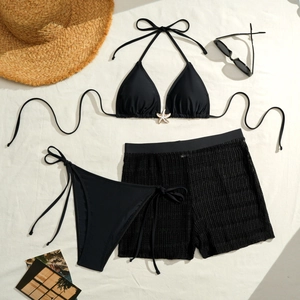 Three-piece solid black bikini set with halter top, swim shorts, and starfish detail