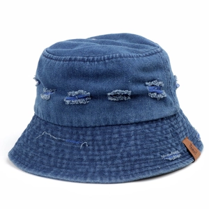 Detail of distressed dark blue denim bucket hat with ripped texture and leather label