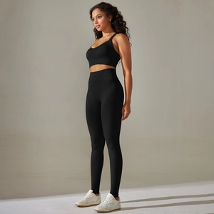 Detail of black seamless yoga set showing racerback sports bra and high waist leggings