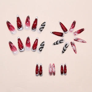 Detail of gothic press on nails featuring silver centipede patterns and dragon motifs
