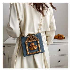 Baroque embossed angel handbag with gold chain and large pearl shoulder strap detail