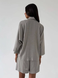 Detail view of the linen texture and back cut of a dark gray shirt and shorts set